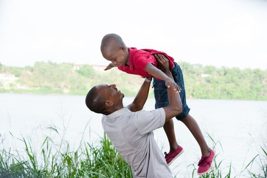 happy family in nature, father and son spending a pleasant time together in nature.Father holding his son in the air