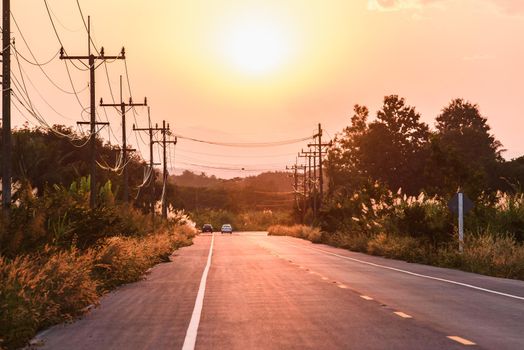 sunset over asphalt road