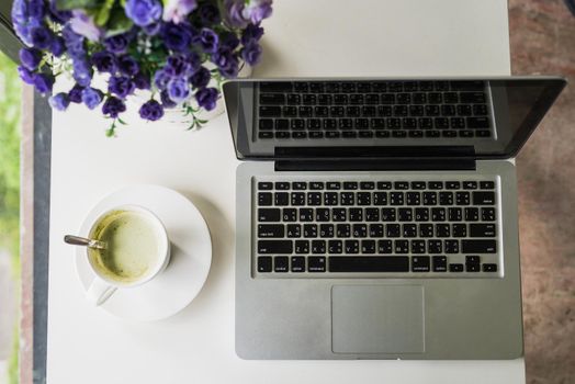 Comfortable workplace at home with laptop and coffee