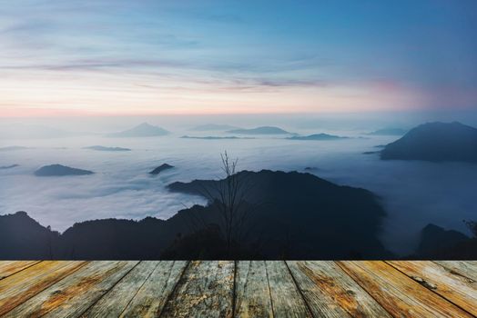 wood floor tourists with taking photo of a valley from top of a mountain