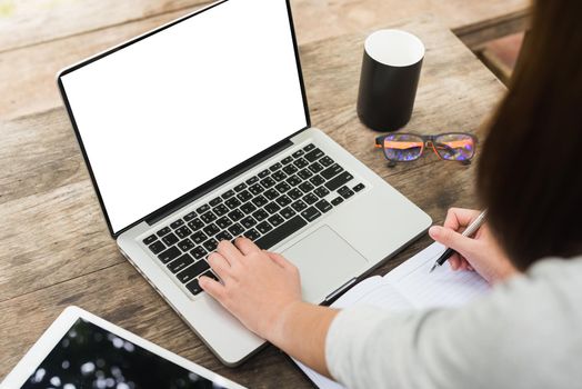 Girl hands. Laptop and cup of tea on wooden table