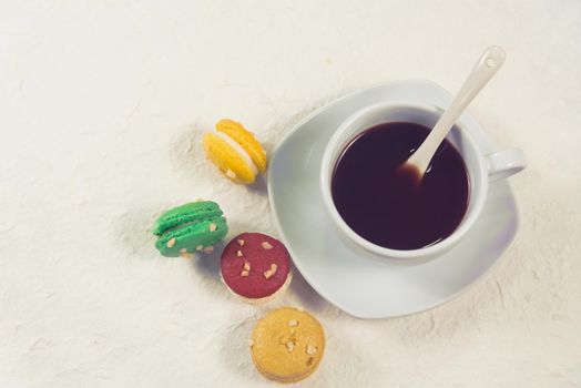 colourful french macaroons with cup of coffee vintage color