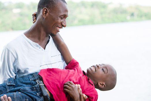 Happy father and little son playing and having fun outdoors .Concept of family, childhood and paternity united and happy
