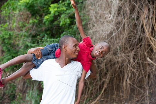 Portrait of father with his son having fun in the park. Family fun happy boy playing with dad outdoors in nature