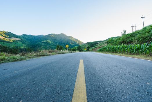 Winding road mountain blue sky