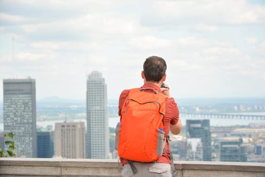man looking at Montreal downtown skyline cityscape. Canada.