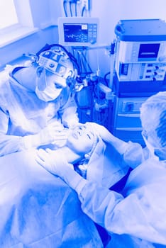 Man surgeon at work in operating room.