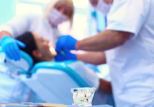 Dentist man with patient woman in clinic.