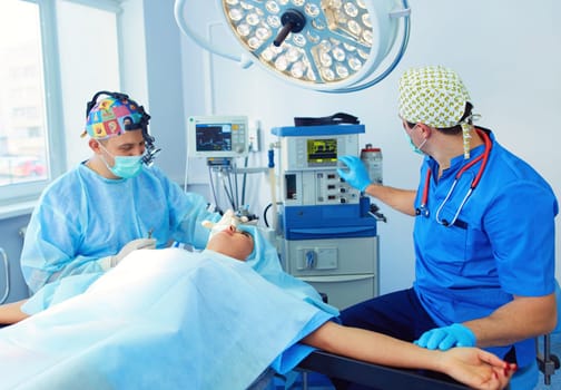 Man surgeon at work in operating room.