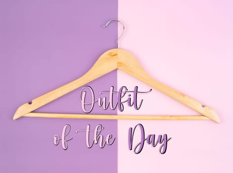 Blank wooden cloth hanger on beautiful background. Outfit of the day concepts.