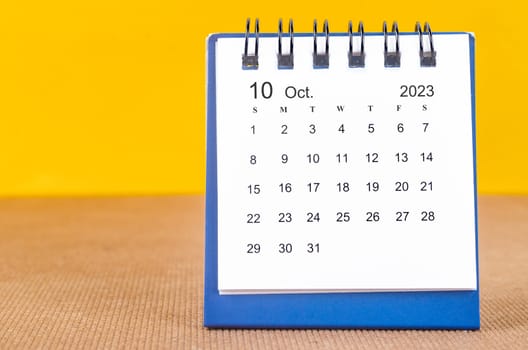 October 2023 Monthly desk calendar for 2023 on yellow background.