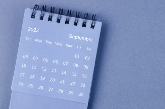 September 2023 Monthly desk calendar for 2023 year on blue background.