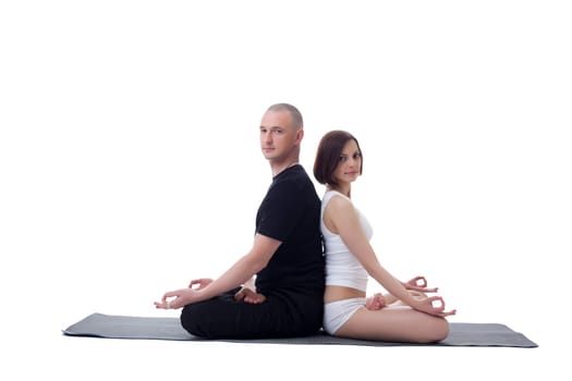 European couple doing yoga in studio, isolated on white
