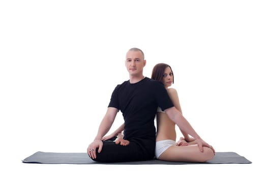 Handsome yoga couple posing in lotus position, isolated on white