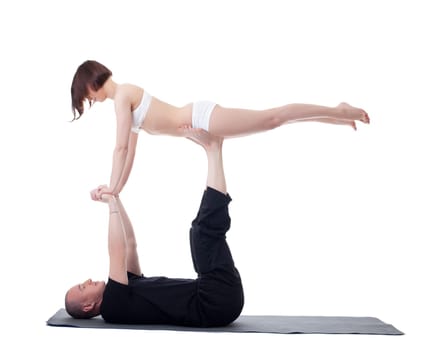 Couple of flexible yoga trainers practising in studio