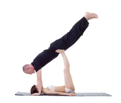 Studio shot of athletic trainers practicing yoga, isolated on white