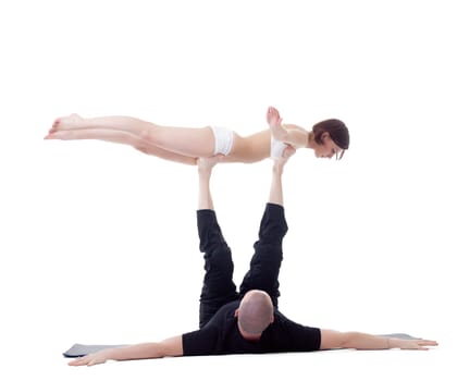 Man and girl doing yoga exercises in studio. Bird Pose.