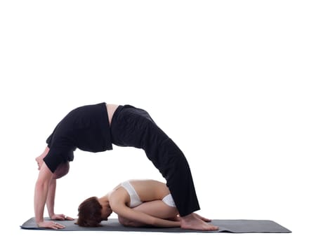 Image of flexible trainers practicing yoga in studio