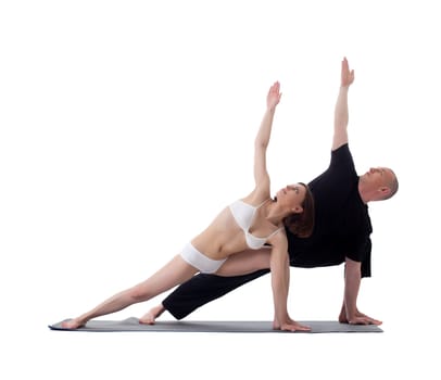 Healthy flexible athletes doing yoga exercises isolated