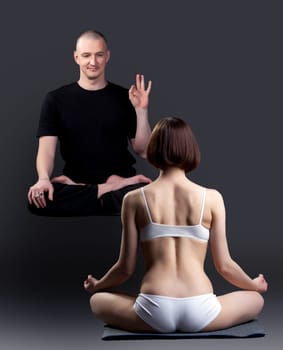 Image of smiling levitating man looks at woman meditates