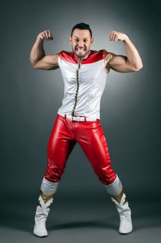 Image of cheerful muscular dancer shows biceps at camera