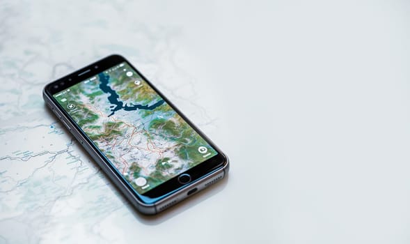 Top view of smartphone lying on a map use for Navigate or GPS. copy space. Empty space for text. technology,maps,mobile concept navigation