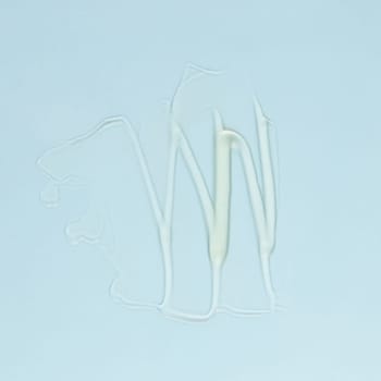 Smear of transparent cream for face and body on a blue background