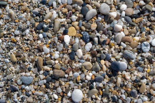 Crushed stone on the seashore. Selective focus on object. The stones were laid on the ground in the garden as a background. Background blur. Pebble stones background.