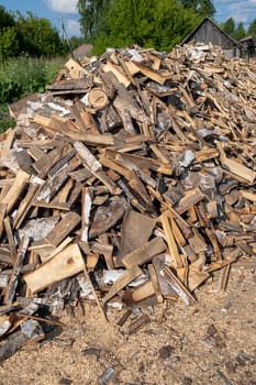 A large pile of different sawn firewood for the stove. Preparing firewood for the winter. Firewood background.