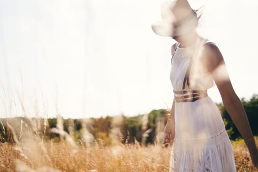 Portrait of woman in golden sunset light in outdoor meadow. Springtime and summer lifestyle. Wellbeing and zen like meditation activity in outdoor. Loving life