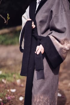 Beautiful dramatic young woman wearing kimono with cherry blossoms, sakura view. High quality photo