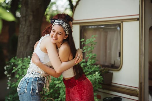 Happy hippie friends are having a good time together in camper trailer. Holiday, vacation, trip concept. High quality photo