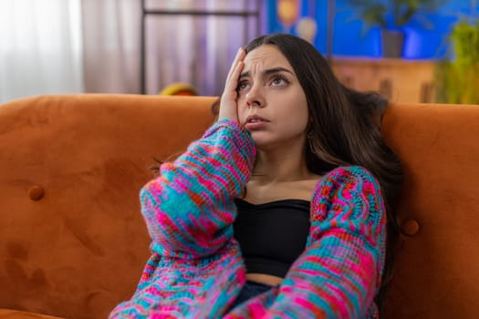 Sad lonely woman lying at home room looks pensive thinks over life concerns, unrequited love suffers from unfair situation. Caucasian alone girl problem break up, depressed feeling bad annoyed burnout