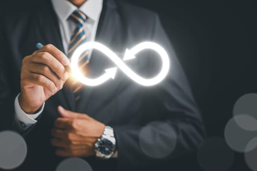 Businessman draws focus to infinity symbol, representing unlimited connection in data technology. Cyber space, future unlimited. Infinite power, energy, internet information. technology infinity data