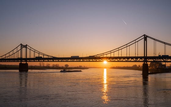 Old bridge crossing the Rhine river during sunset, Krefeld, North Rhine Westphalia, Germany