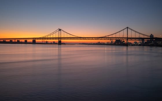 Old bridge crossing the Rhine river during sunset, Krefeld, North Rhine Westphalia, Germany