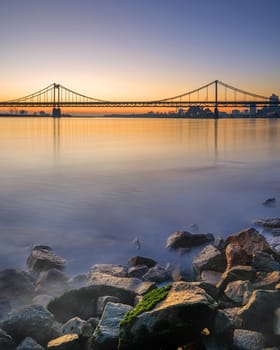 Old bridge crossing the Rhine river during sunset, Krefeld, North Rhine Westphalia, Germany