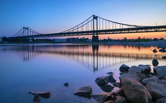 Old bridge crossing the Rhine river during sunset, Krefeld, North Rhine Westphalia, Germany