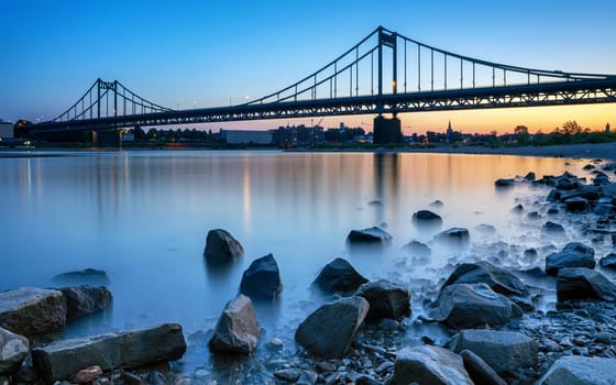 Old bridge crossing the Rhine river during sunset, Krefeld, North Rhine Westphalia, Germany