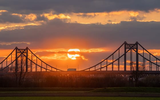 Old bridge crossing the Rhine river during sunset, Krefeld, North Rhine Westphalia, Germany