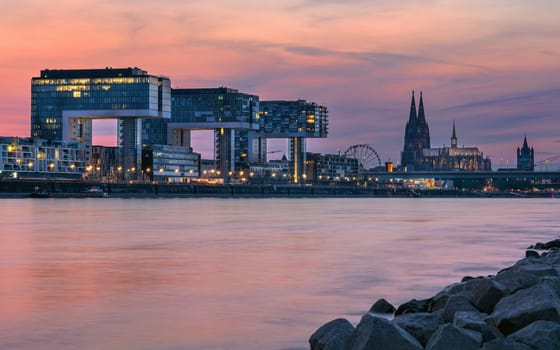 COLOGNE, GERMANY - JUNE 23, 2023: Panoramic image of modern buildings in the harbor of Cologne during sunset on June 23, 2023 in Germany, Europe