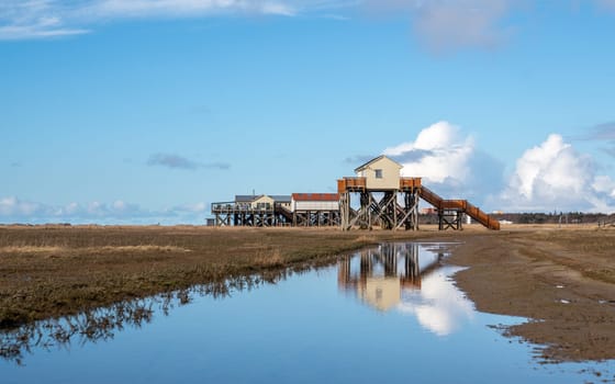 SANKT PETER ORDING, GERMANY - MARCH 8, 2023: Panoramic image of beach houses of Sankt Peter Ording close to the North Sea on March 8, 2023 in North Frisia, Germany