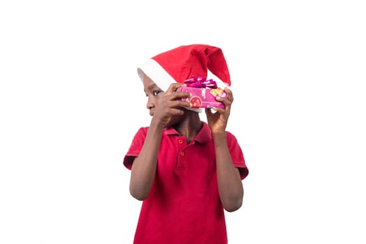 Unpack the Christmas present. Happy childhood concept. Holiday and party tradition. Kid with a Christmas present in hand.