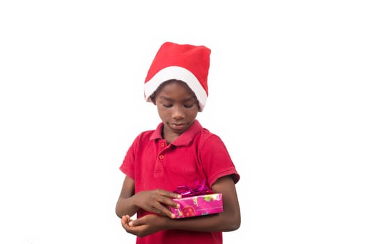 Unpack the Christmas present. Happy childhood concept. Holiday and party tradition. Kid with a Christmas present in hand.