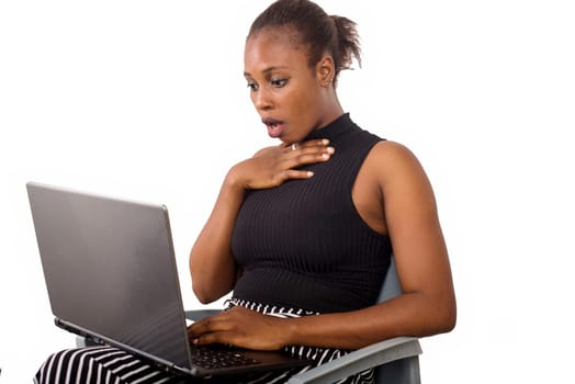 surprised business woman looks on laptop. Charming beautiful woman holding a laptop and looking for some business information.