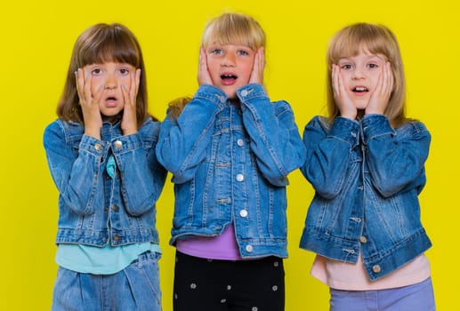 Oh my God, Wow. Little child sisters looking surprised at camera with big eyes, shocked by sudden victory, game winning lottery goal achievement, good news. Three siblings children kids. Teenage girls