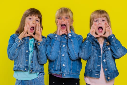 Expressive teenage girls holding hands near mouth loudly screaming, shouting, yelling, announces discounts sale Hurry up, welcomes someone hello. Little children sisters. Three female siblings kids