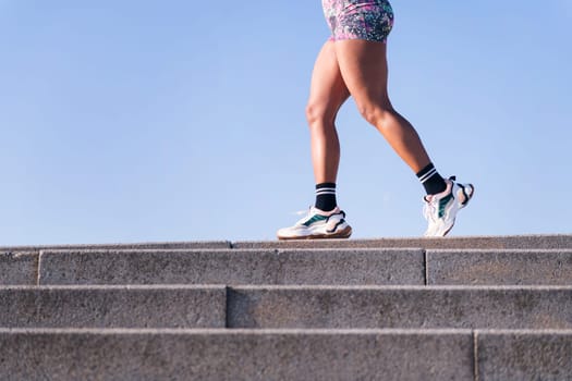 cropped photo of the legs of an unrecognizable african american woman running outdoors, concept of sports and active lifestyle, copy space for text