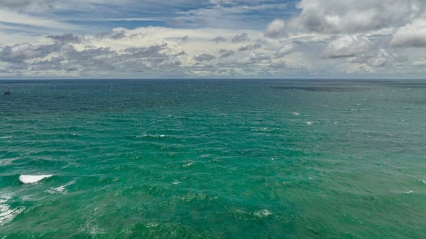 Blue ocean with waves and blue skies with clouds. Seascape in the tropics. Borneo, Malaysia.