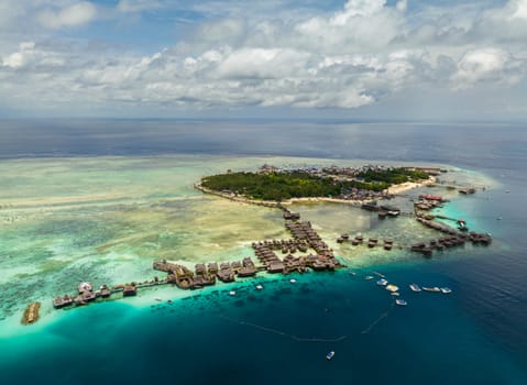 Aerial view of tropical island of Mabul with a beautiful beach and coral reef. Semporna, Sabah, Malaysia.